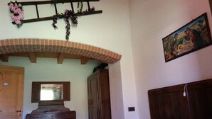 A bedroom with a bed, wooden wardrobe, dresser, and a mirror. - Holiday home with garden and mountain view (Velo d Astico)