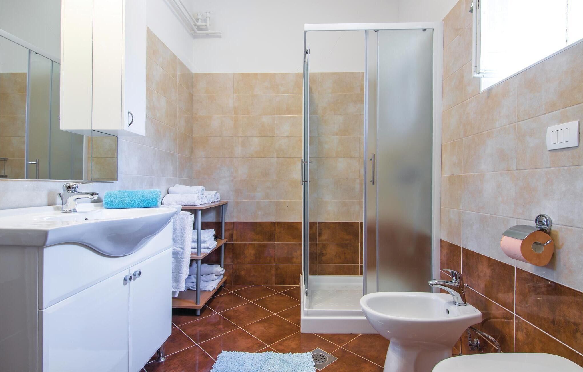Une salle de bain équipée d’une douche, d’un lavabo et d’un bidet.