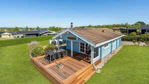 A single-story house with a blue exterior and a wooden deck. - 3 bedroom amazing home in Egernsund (Egernsund)
