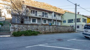 A two-story building with a stone wall and a balcony. - 2 bedroom gorgeous apartment in Knezica (Knezica)