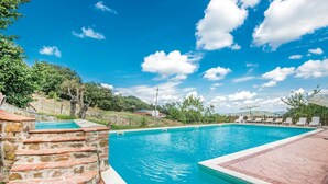 A swimming pool with stone steps leading into it, surrounded by a brick patio and a view of hills and trees. - Amazing home in Arcidosso GR (Arcidosso GR)