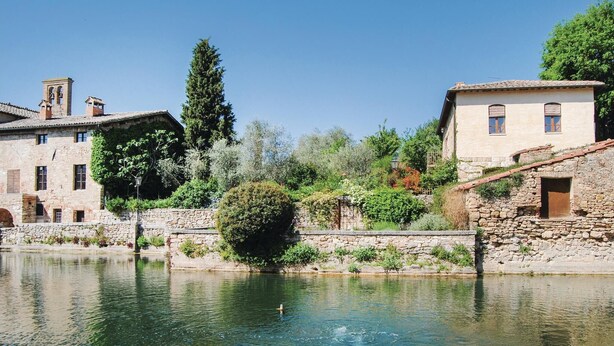 A historic stone building with a bell tower, situated beside a clear river. - Amazing home in Arcidosso GR (Arcidosso GR)