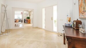 A spacious hallway with a tiled floor, leading to a room with a desk and chair. - Beach front home in Marbella (Marbella)