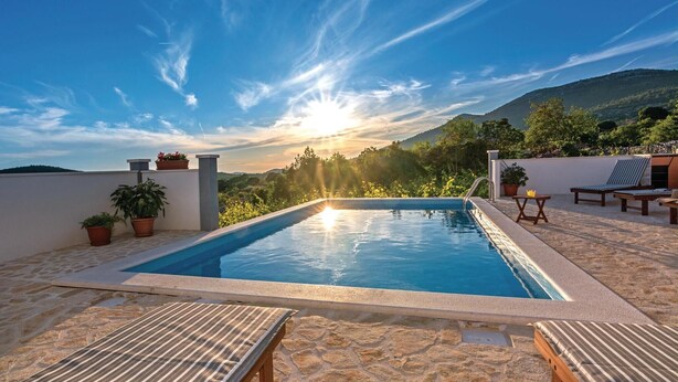 A rooftop pool with a clear view of the sunset and surrounding hills. - Beautiful home in Blizina Gornja (Blizina Gornja)