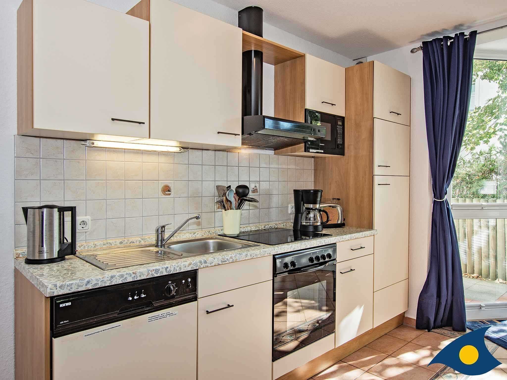 A modern kitchen with a dishwasher, stove, oven, and microwave.