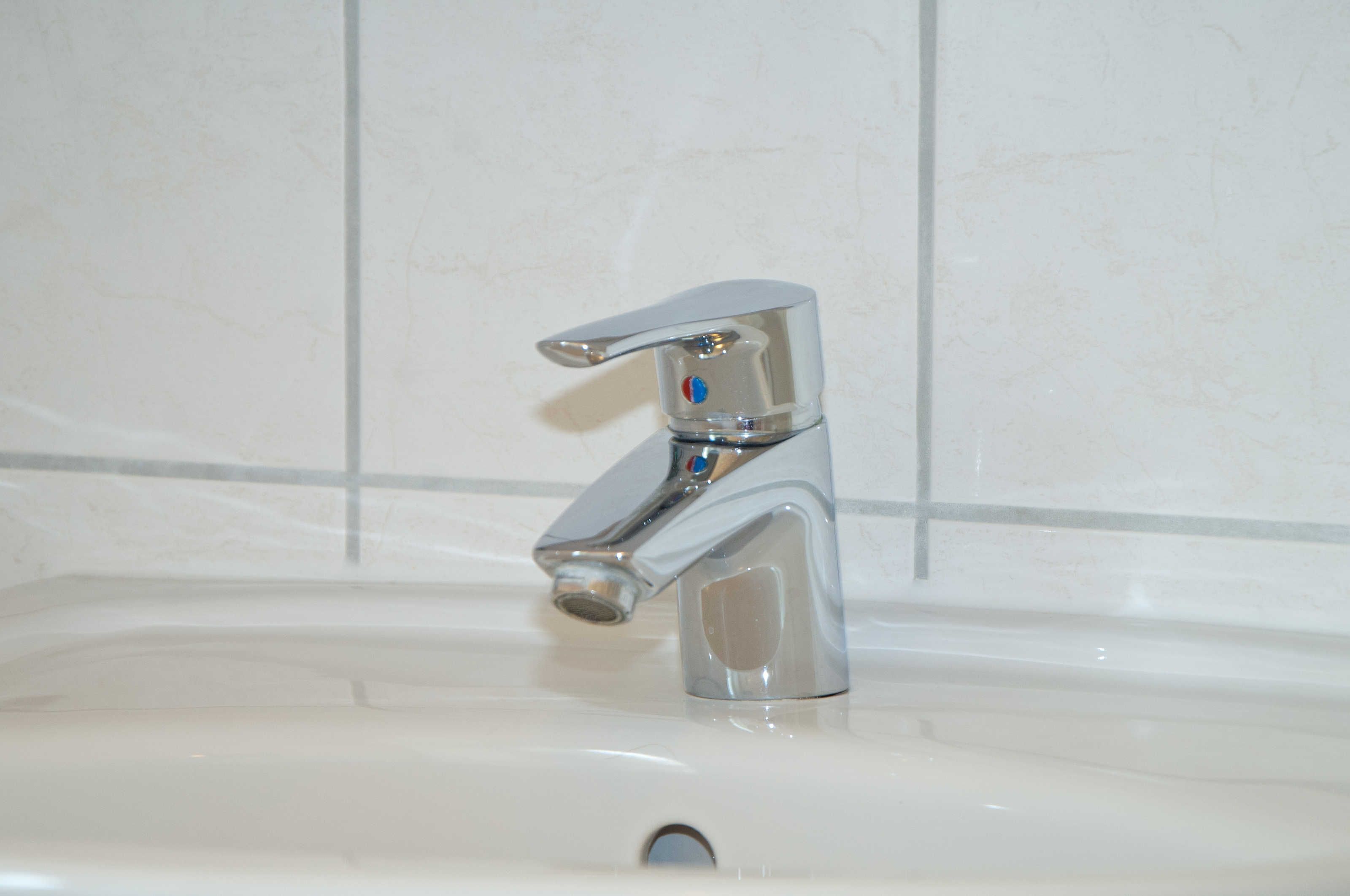 A bathroom sink with a chrome faucet and a single-handle design.