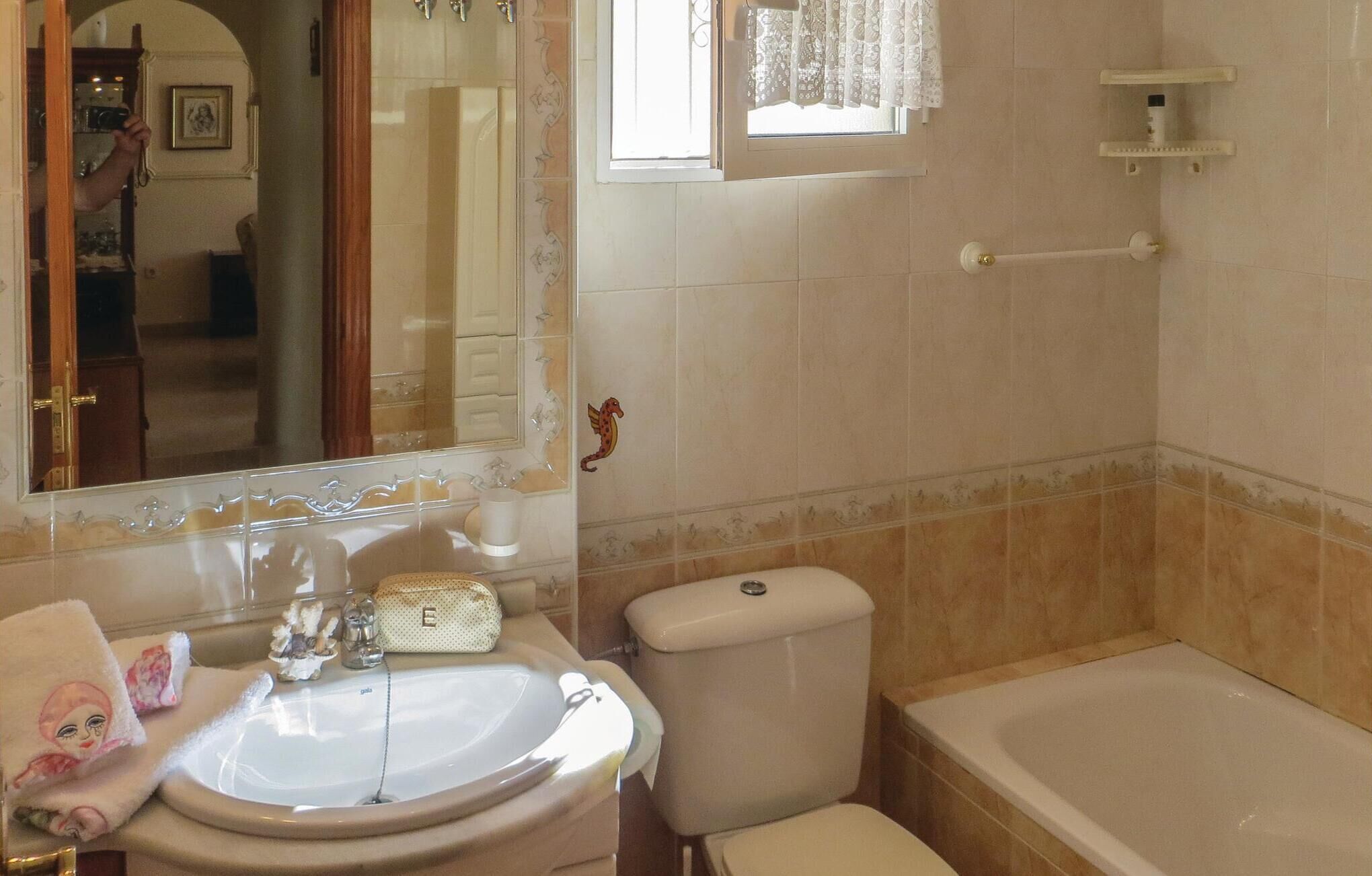 A bathroom with a sink, toilet, and bathtub.