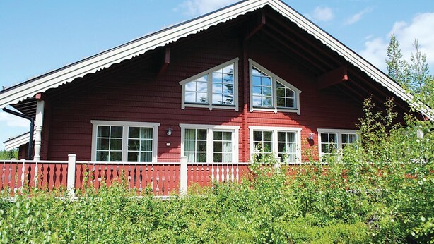 A red wooden house with a white fence, large windows, and a sloped roof. - Awesome home in Sälen with sauna (Sälen)