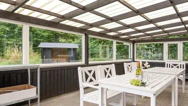An outdoor patio with a grill, white wooden furniture, and large windows. - Amazing home in Oksbøl with sauna (Oksbøl)