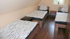 A small, single-room apartment with two single beds, a window, and a wooden floor. - Apartment 1 - Rügen apartment 119 (Garz/Rügen)