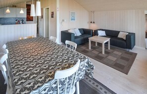 Relax in this stylish room with a large bed, dining area, and cozy seating space.