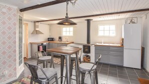 A compact kitchen with a central island, a stove, and basic appliances.