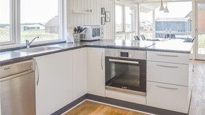 A modern kitchen with white cabinetry, a Bosch oven, a microwave, and a dishwasher. - Nice home in Harboøre with sauna (Harboøre)