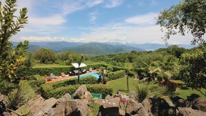 A pool area with a white canopy, surrounded by lush greenery and mountains in the background. - Amazing home in Acquavena di R. (SA) (Acquavena di R. (SA))