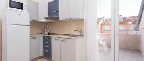 Fridge, microwave, stovetop, coffee/tea maker