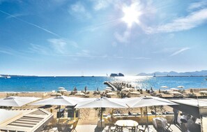 A beachside restaurant with outdoor seating and umbrellas, overlooking the sea. - 1 bedroom cozy apartment in Cannes (Cannes)