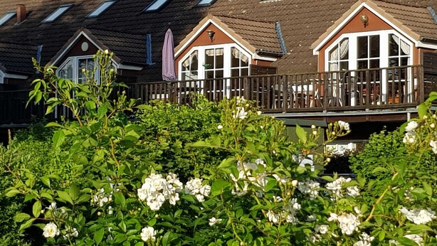 Una hilera de casas tradicionales con tejados inclinados y ventanas de tejado.