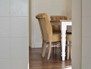 A dining area with a wooden table and matching chairs.