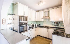 Fridge, stovetop, dishwasher, coffee/tea maker