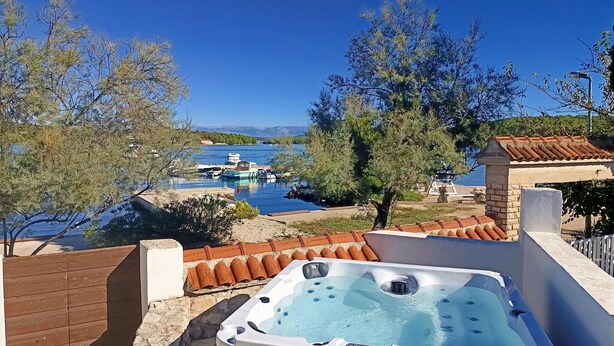 A hot tub with a clear view of a marina and boats in the background.