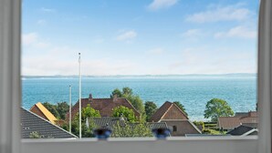 A view of a residential area with houses and a body of water in the background. - Stunning home in Sjølund with kitchen (Sjølund)