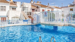A swimming pool with a white fence and a no diving sign. - Amazing apartment in Torrevieja with WiFi (Torrevieja)