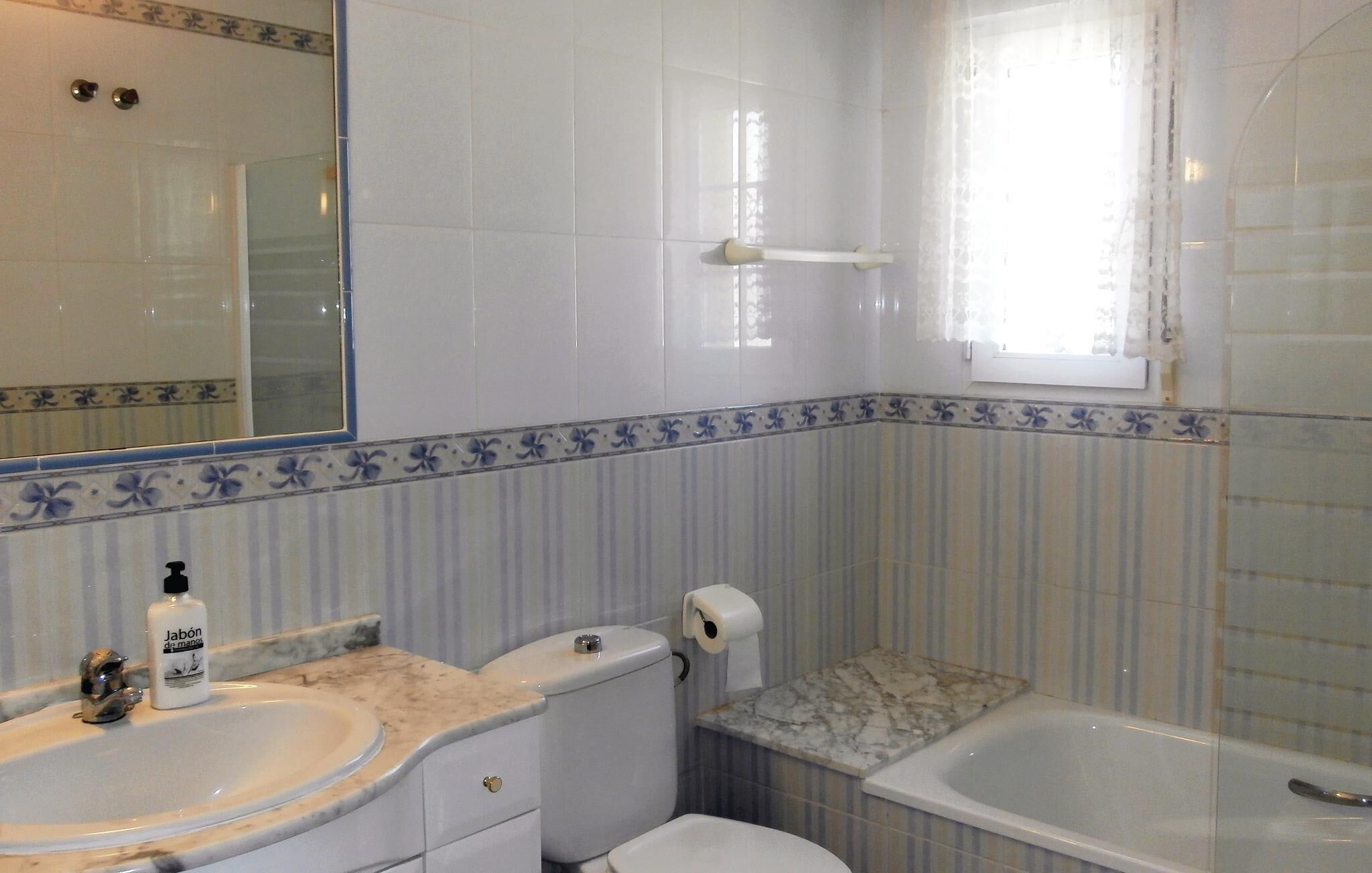 A bathroom with a sink, toilet, and bathtub.