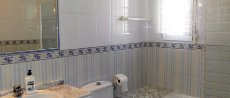 A bathroom with a sink, toilet, and bathtub.