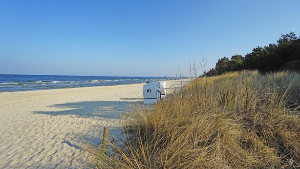 A beach with a white structure labeled 'M3' in the foreground, sandy beach, and ocean in the background.