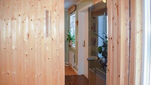 A wooden interior hallway leading to a glass door with a shower. - Lovely home in Ryd with sauna (Ryd)