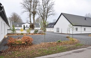 Homes with pitched roofs line a quiet residential street.