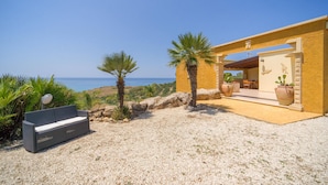 A coastal property with a patio, outdoor seating, and a view of the sea. - Beach front home in Ribera (AG) (Ribera (AG))