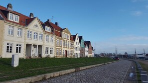 Une rangée de bâtiments de style européen traditionnel, avec une rue pavée devant.