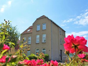 A multi-story building with a symmetrical facade, multiple windows, and a visible entrance. - KR-07 - Karl-Risch-Str. 7 units. Above. (Kühlungsborn)