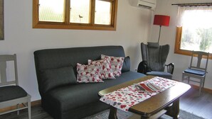 A living room with a grey sofa, a wooden coffee table, and a red floor lamp. - 2 bedroom stunning home in Unnaryd (Unnaryd)