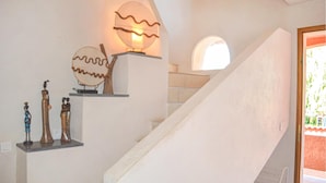 A staircase with a white wall and a round window at the top. - Stunning home in Moriani Plage (Moriani Plage)