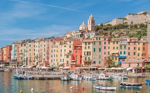 A coastal town with colorful buildings, a prominent church, and a marina with boats. - Cozy home in Porto Venere SP with WiFi (Porto Venere SP)