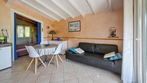 A compact living space with a dining area, a sofa, a table, and a kitchenette. - Nice home in Sarrians with WiFi (Sarrians)