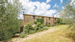 A stone building with a sloped roof, surrounded by olive trees and a grassy path. - Stunning apartment in San Vito in Monte TR with outdoor swimming pool (San Vito in Monte TR)