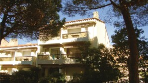 A multi-story building with balconies, surrounded by trees. - Gorgeous apartment in Argeles sur Mer (Argeles sur Mer)