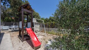 Un parque infantil con un tobogán de madera y una estructura para escalar.