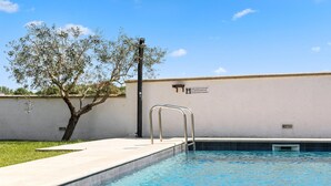 A swimming pool with a metal ladder and a sign on the wall. - Beach front home in Valbandon (Valbandon)
