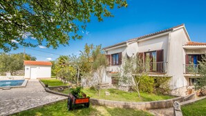 A two-story house with a balcony, a swimming pool, and a garden with a cart. - Stunning home in Malinska (Malinska)
