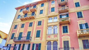 A multi-story building with balconies, arched windows, and a mix of yellow and pink facade colors. - Pet friendly apartment in Rapallo -GE- (Rapallo -GE-)