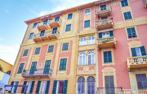 A multi-story building with balconies, arched windows, and a mix of yellow and pink facade colors. - Pet friendly apartment in Rapallo -GE- (Rapallo -GE-)