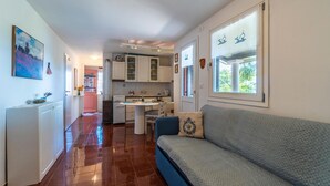 A compact kitchen with white cabinets and a dining area. - 2 bedroom beautiful home in Labin (Labin)