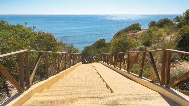 A wooden staircase leading to a beach with a clear view of the ocean. - 2 bedroom beautiful home in La Florida (La Florida)