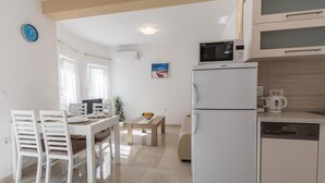 A compact kitchen with a refrigerator, microwave, and coffee maker.
