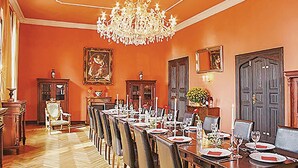 A formal dining room with a long table set for a meal, surrounded by chairs. - Beautiful home in Schwasdorf with sauna (Schwasdorf)