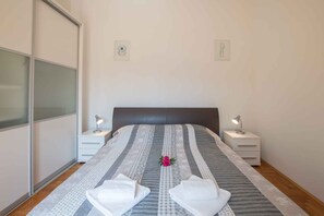 Comfortable retreat with a neatly made bed, bedside tables, and simple wall art.